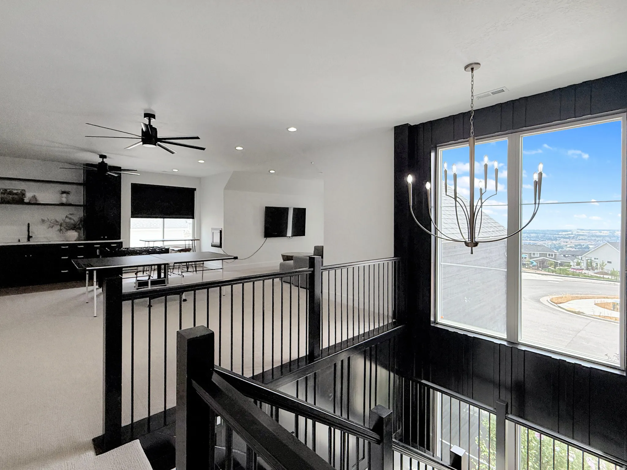 Modern staircase with black railing and vertical paneling