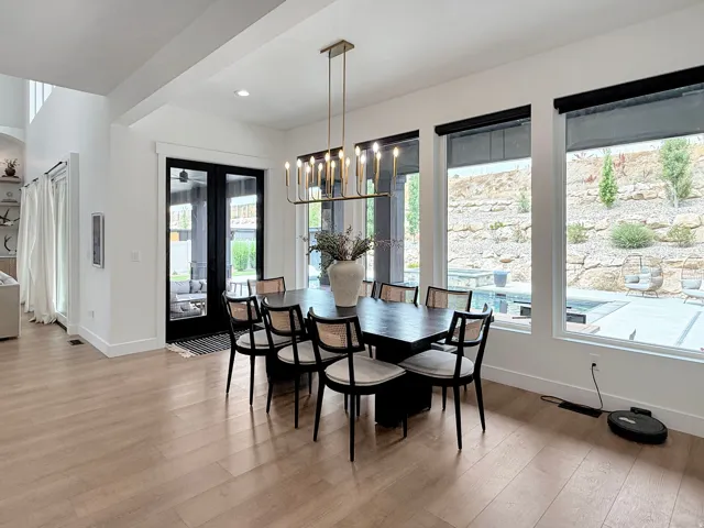 Spacious interior with light wood-finish flooring, high ceilings, and recessed lighting