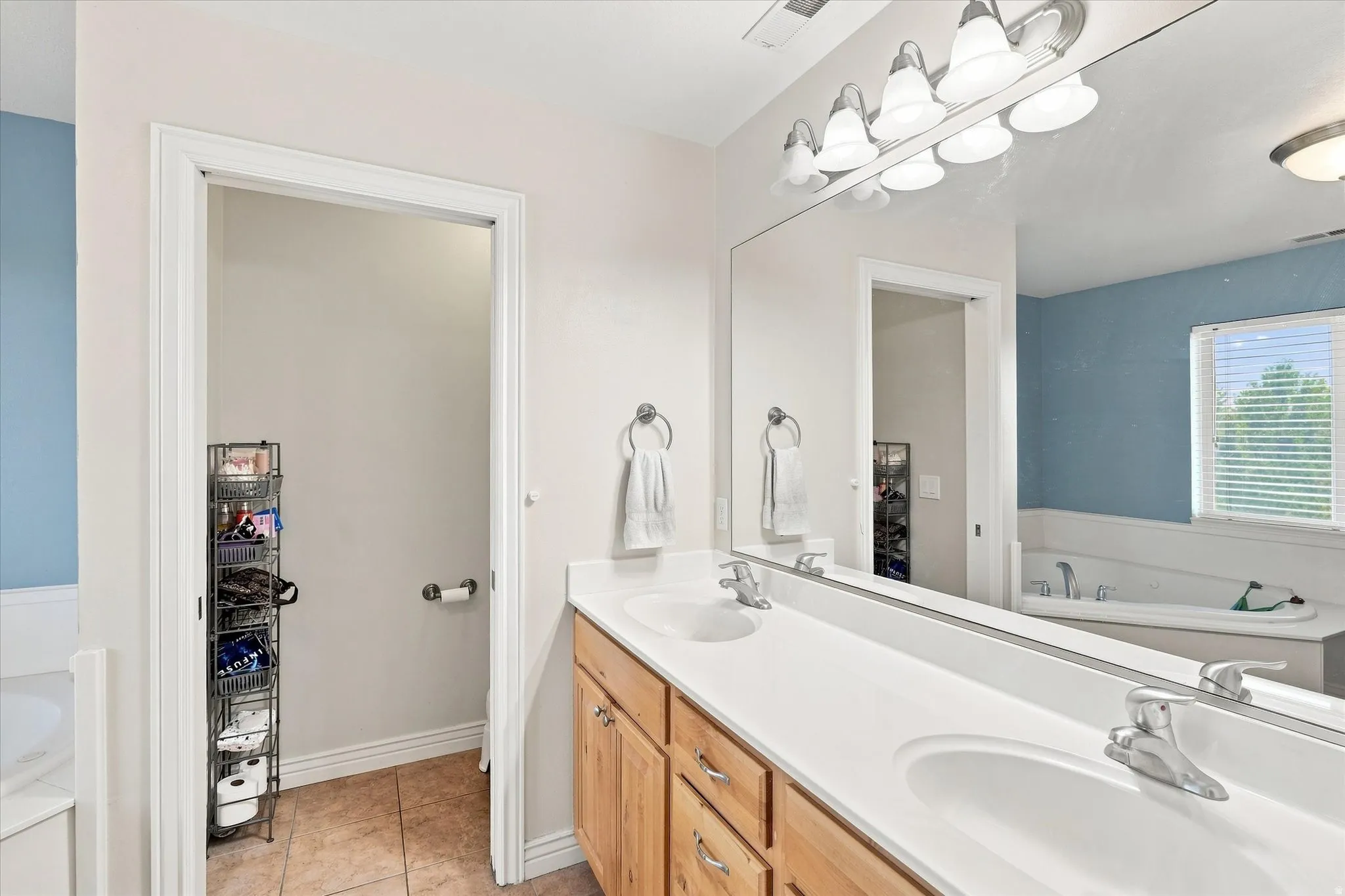 Dual vanity with wood-finish cabinetry and integrated sinks