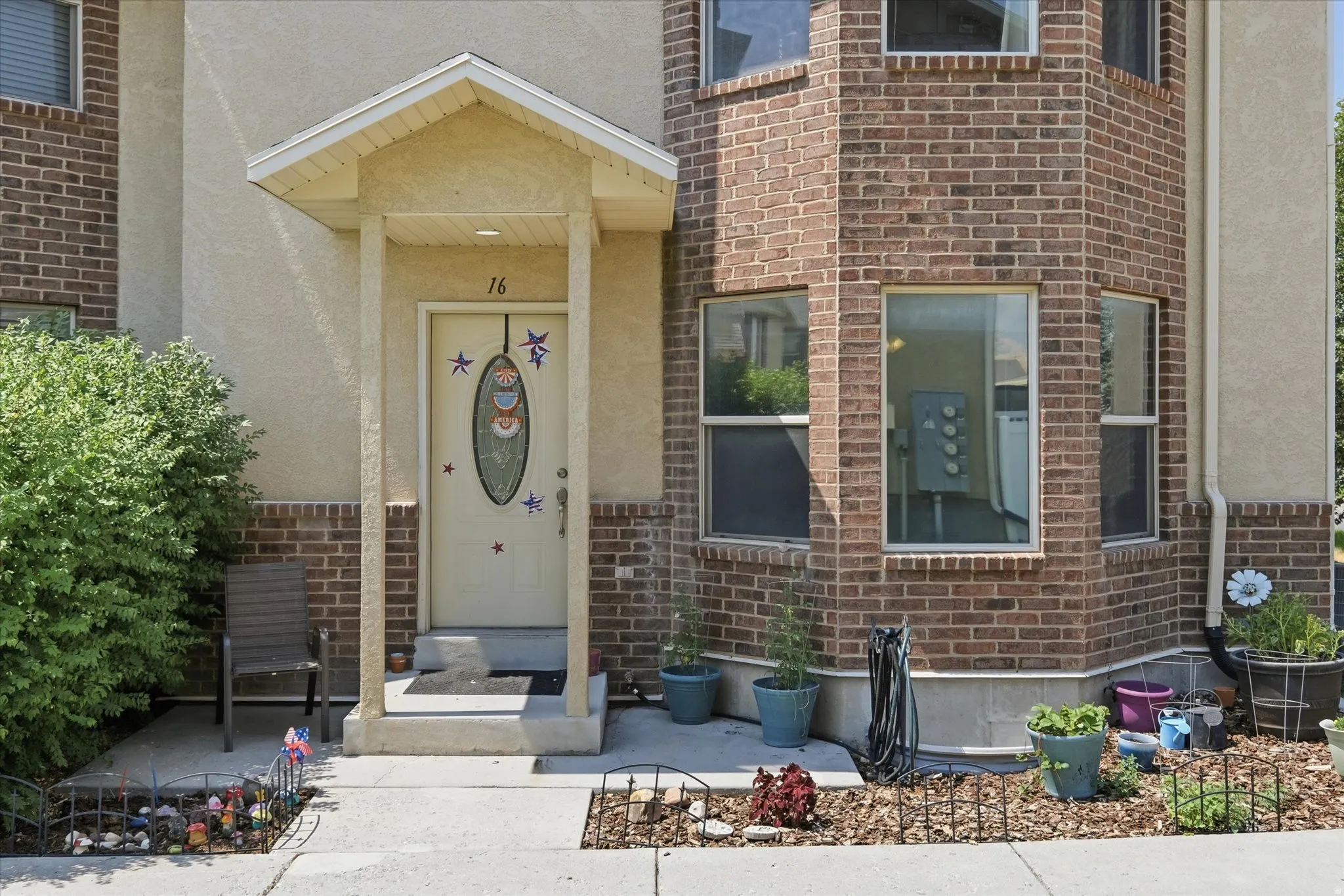 Brick and stucco exterior with multiple windows