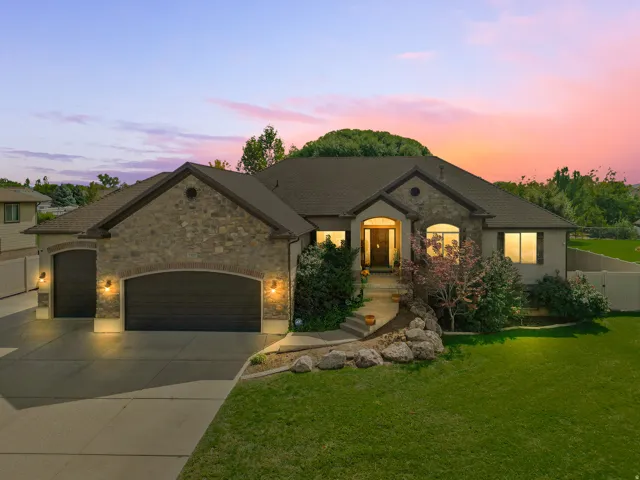 Stone and stucco exterior with multiple gables and a covered entry