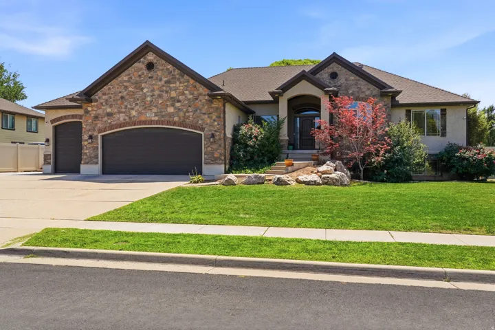 Stone and stucco exterior with a prominent two-car garage