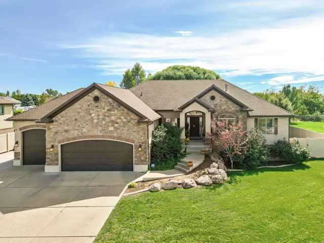 Stone and stucco exterior with an arched entryway