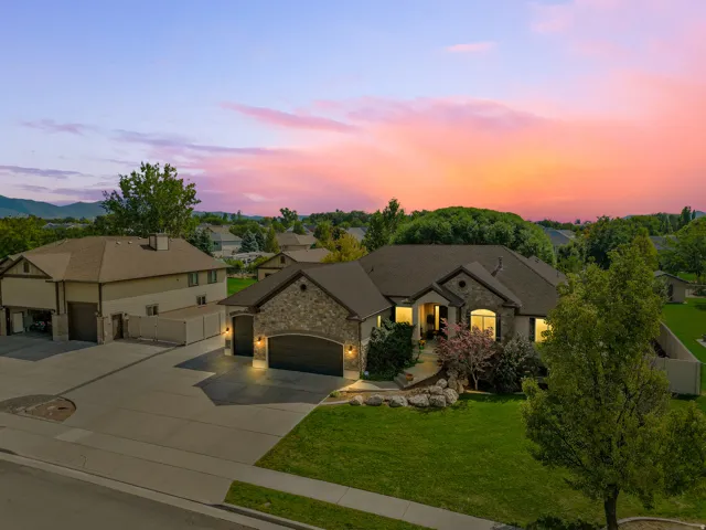 Stone and stucco exterior with an attached two-car garage