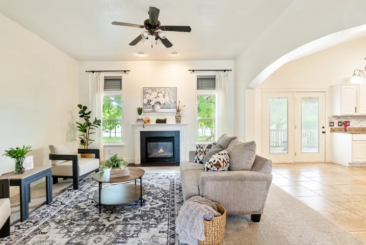Living area with a fireplace, recessed lighting, and a ceiling fan
