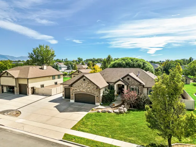 Stone facade and stucco exterior with an attached two-car garage