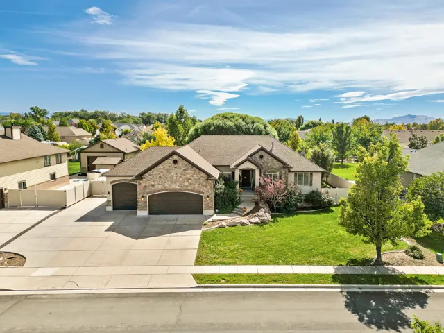 Stone and stucco exterior with an attached two-car garage