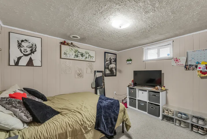 Wall-to-wall carpeting and paneled walls create a comfortable ambiance
