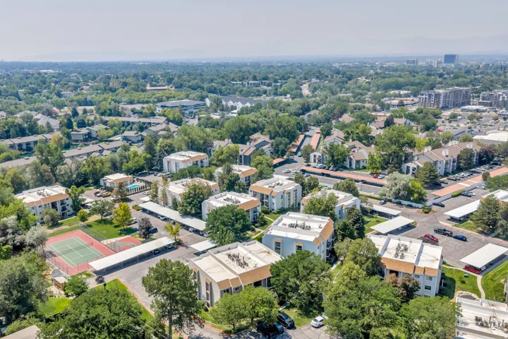 Expansive property with multiple buildings, an outdoor tennis court, and a swimming pool
