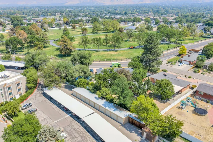 Extensive parking facilities with covered spaces, mature trees, and landscaping