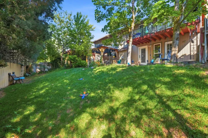 Expansive grassy yard with mature trees