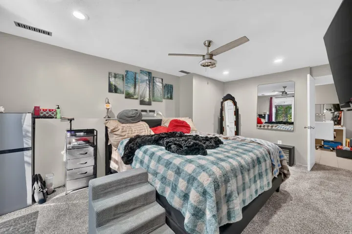 Recessed lighting, ceiling fan, and carpeted flooring