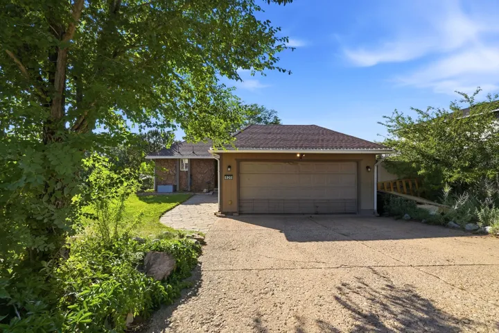 Attached two-car garage with a paved driveway