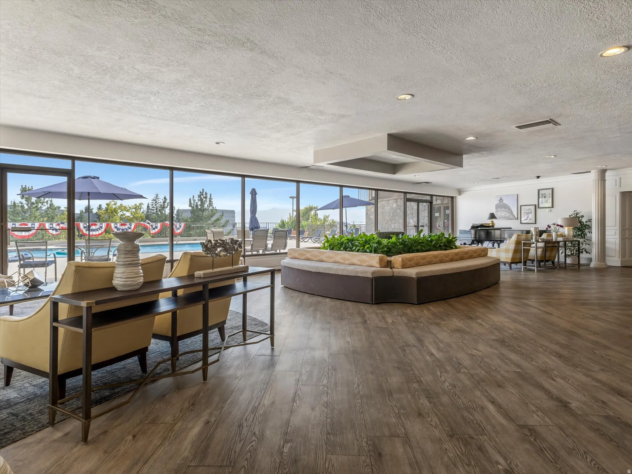 Expansive common area featuring wood-finish flooring and recessed lighting