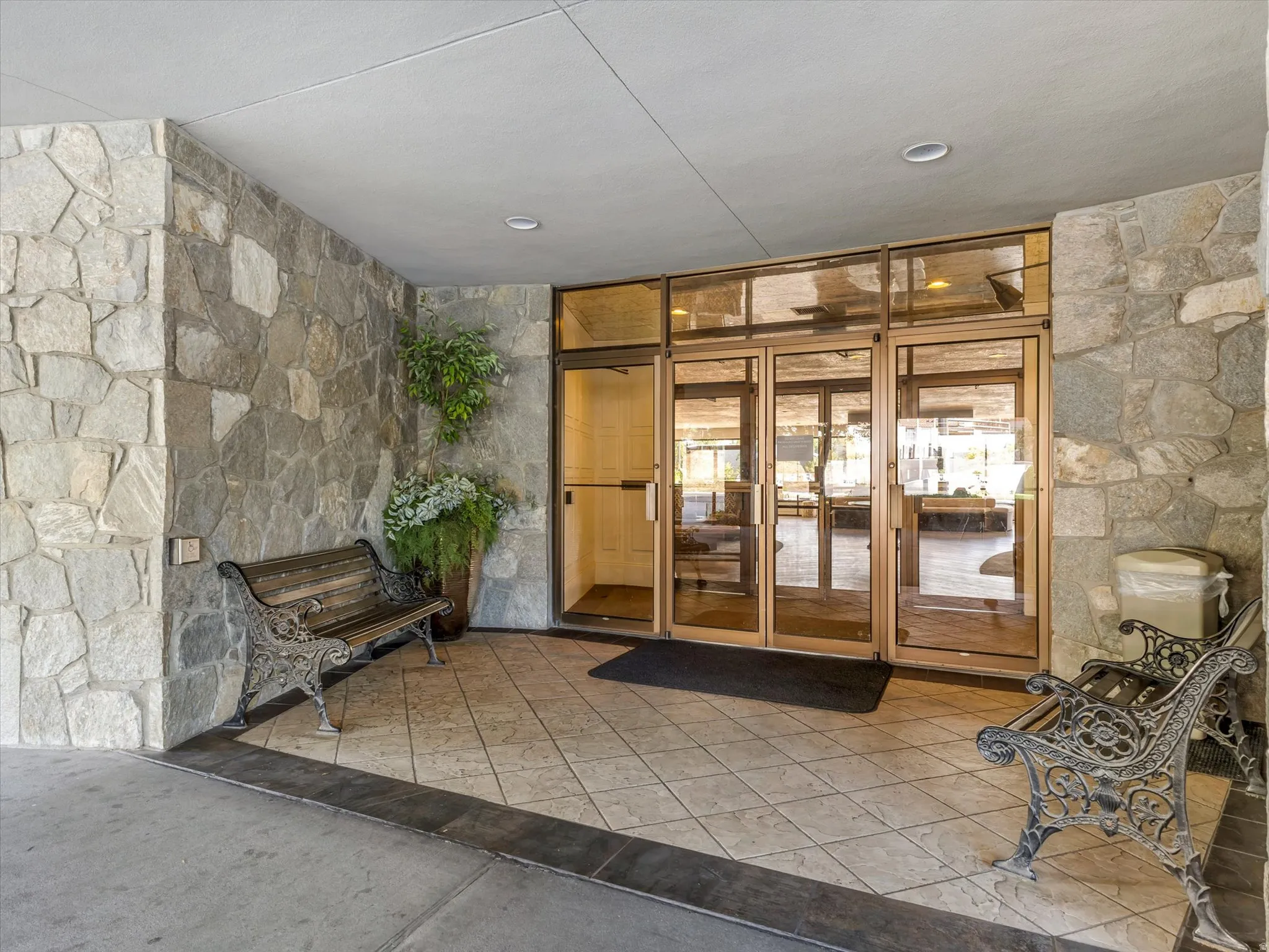 Stone veneer exterior with a covered entry