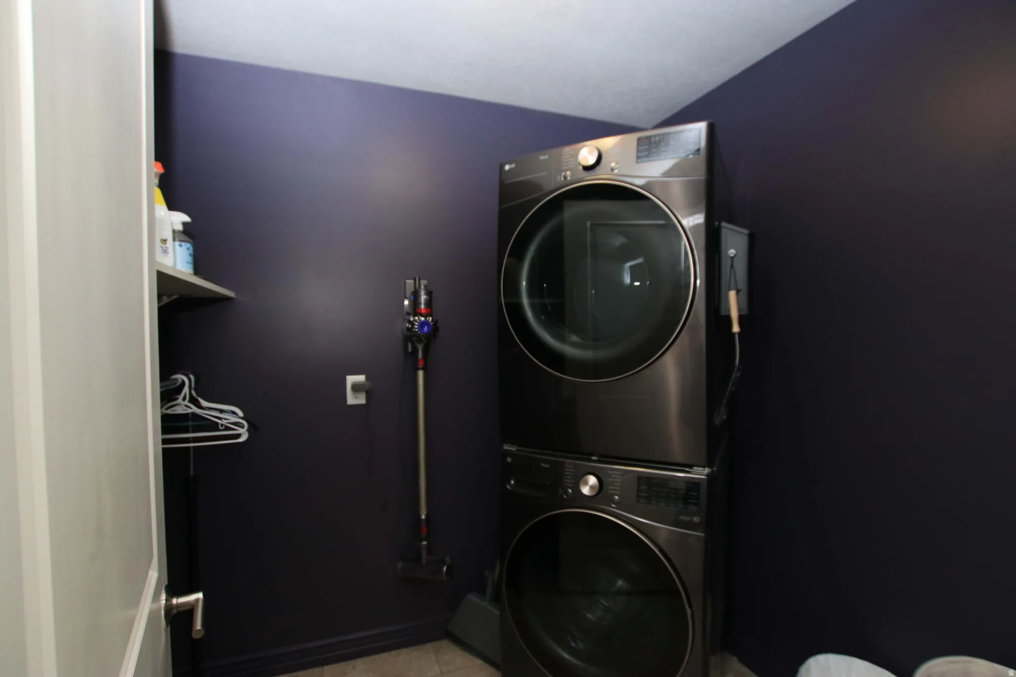 Stackable laundry appliances with a dark wall finish