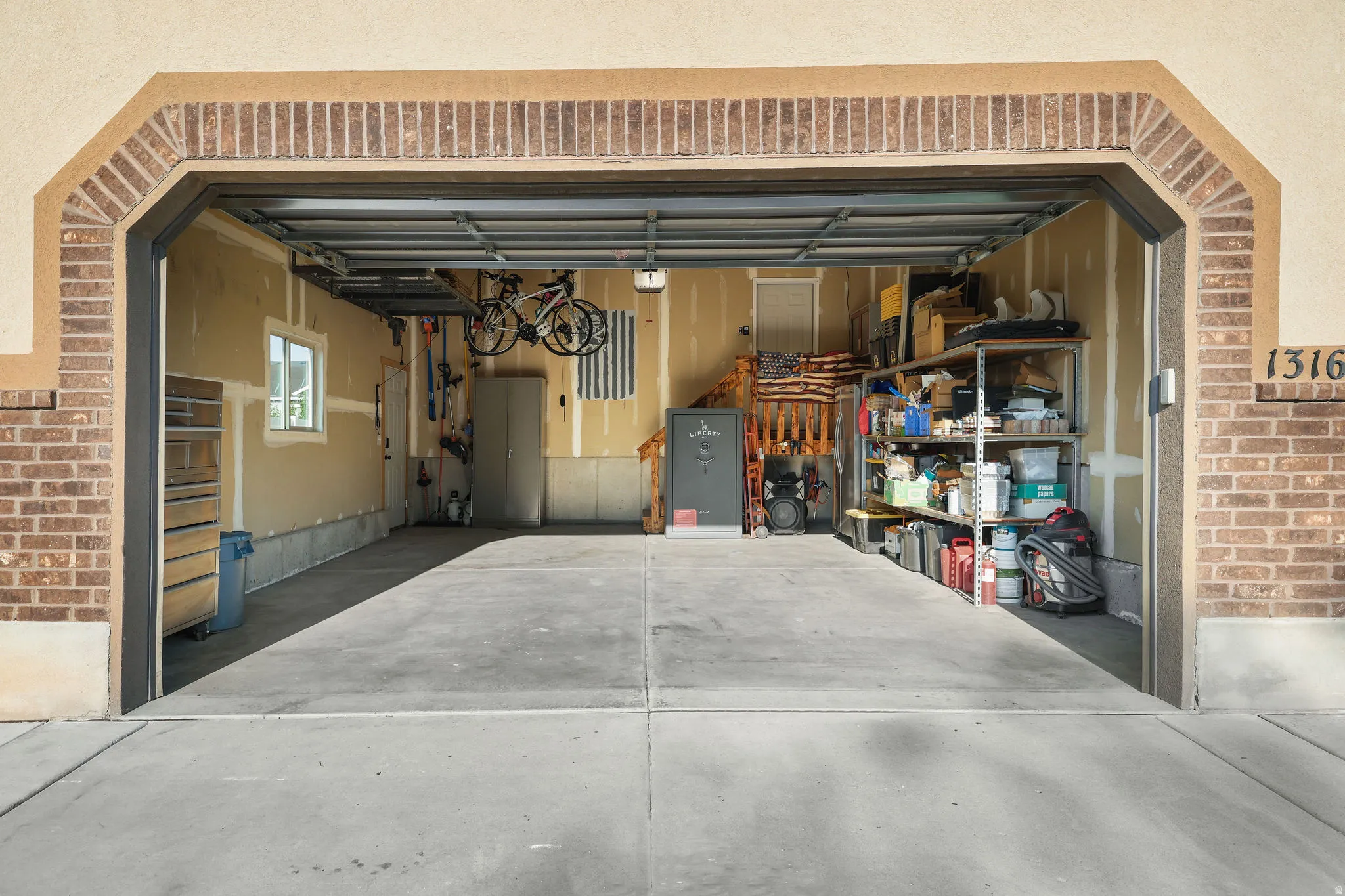 Garage with concrete flooring, overhead garage door, and a window