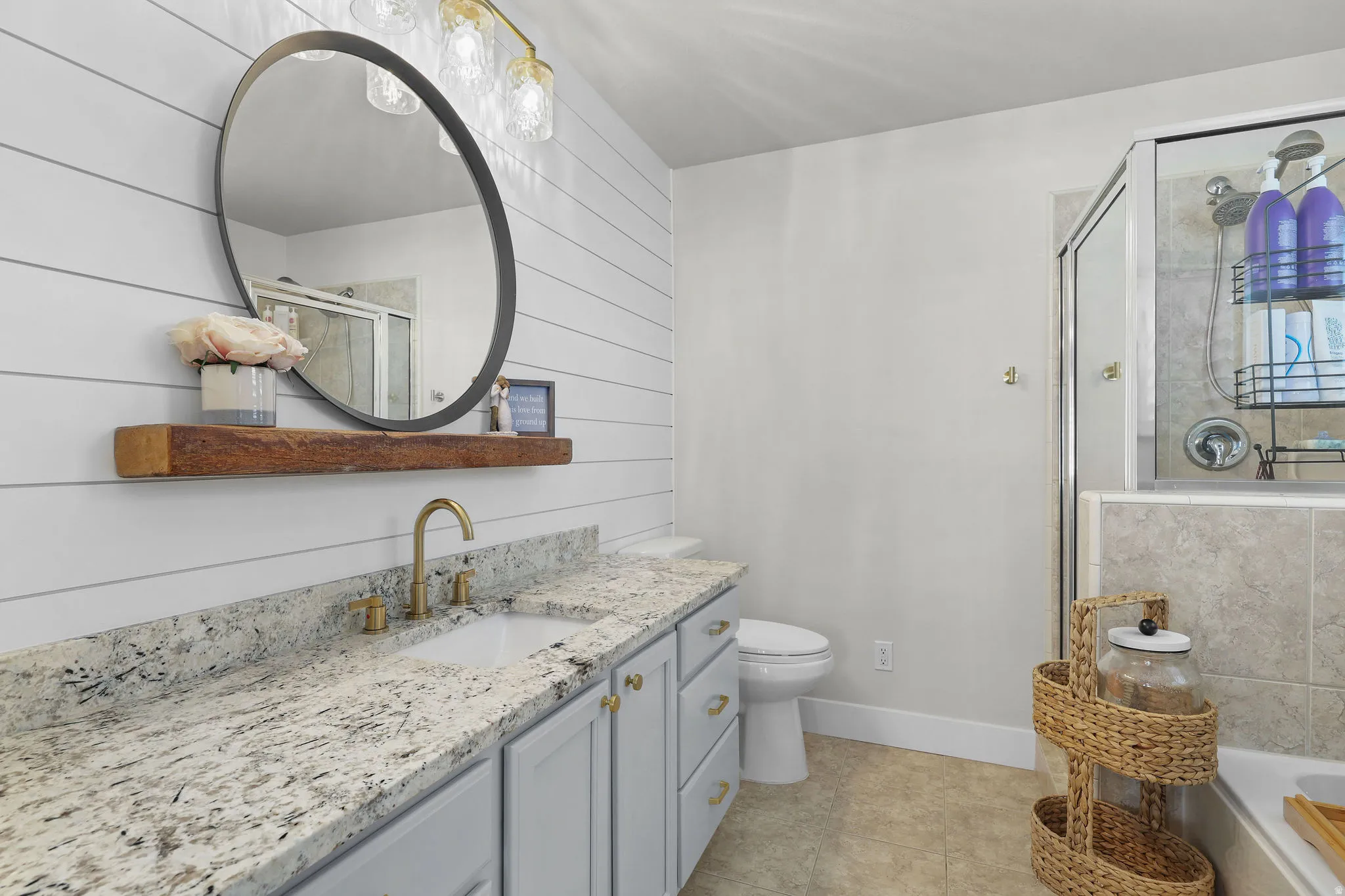 Granite countertop vanity with undermount sink and brass-finish faucet
