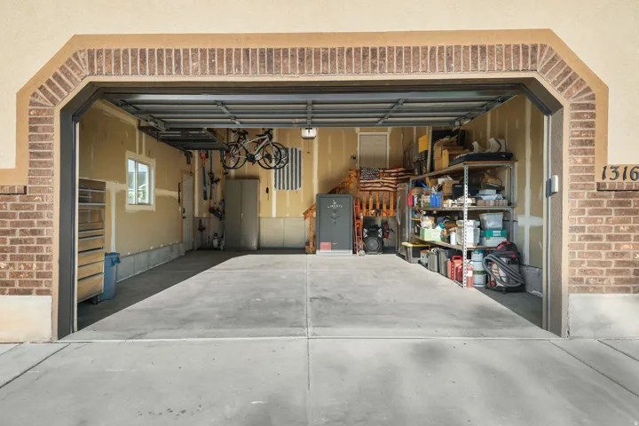 Garage with concrete flooring, overhead garage door, and a window