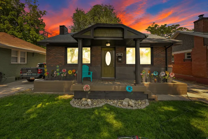 Brick exterior with a covered porch featuring dark support columns