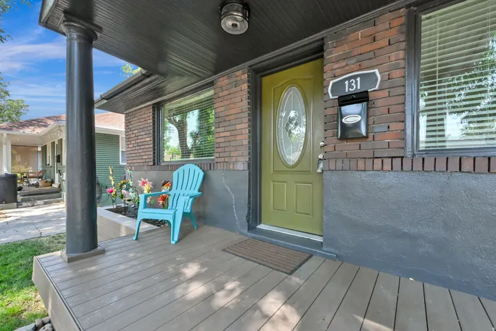Covered front porch featuring wood-finish decking