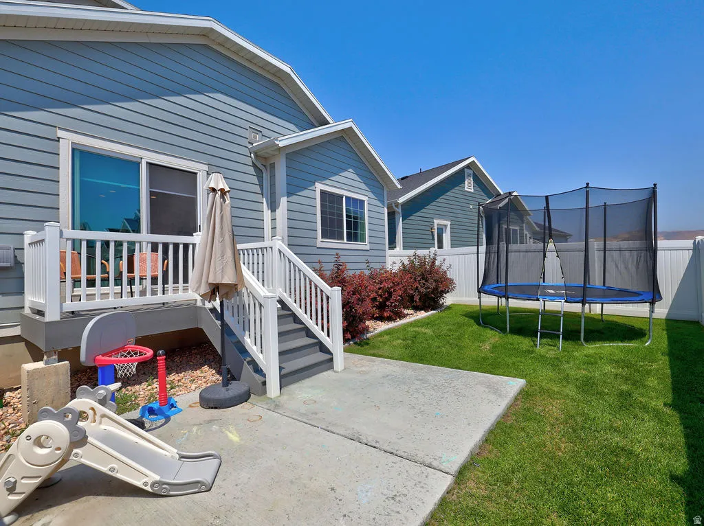 Rear siding with horizontal panels, white trim, and a patio door