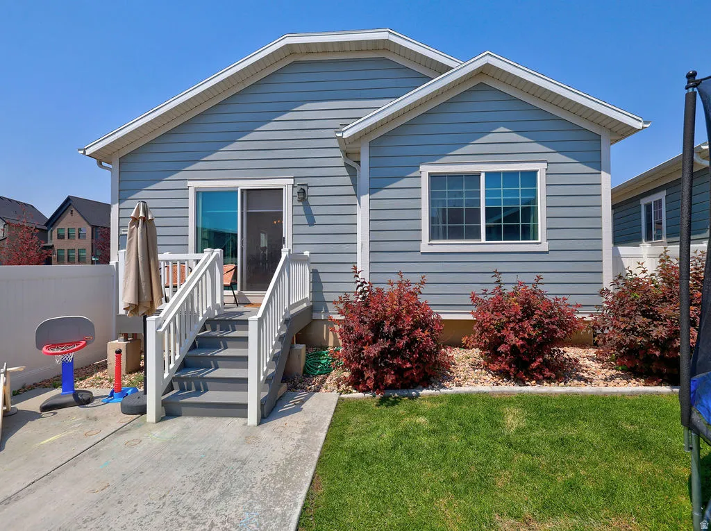 Rear exterior featuring blue horizontal siding and white trim