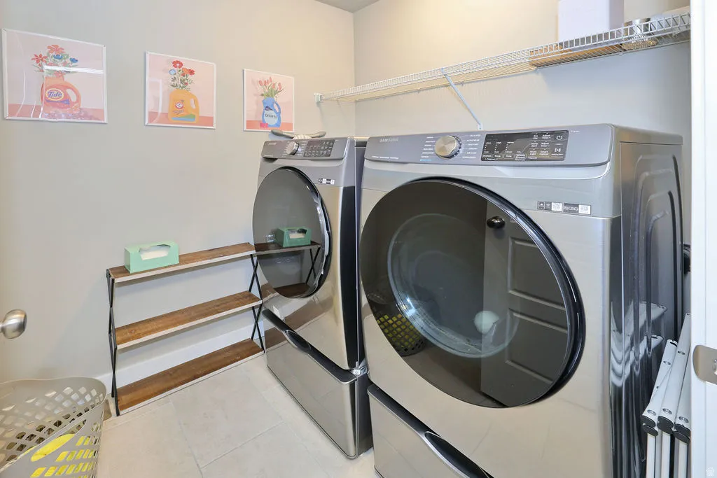 Stainless steel front-load washer and dryer set with an overhead wire shelf