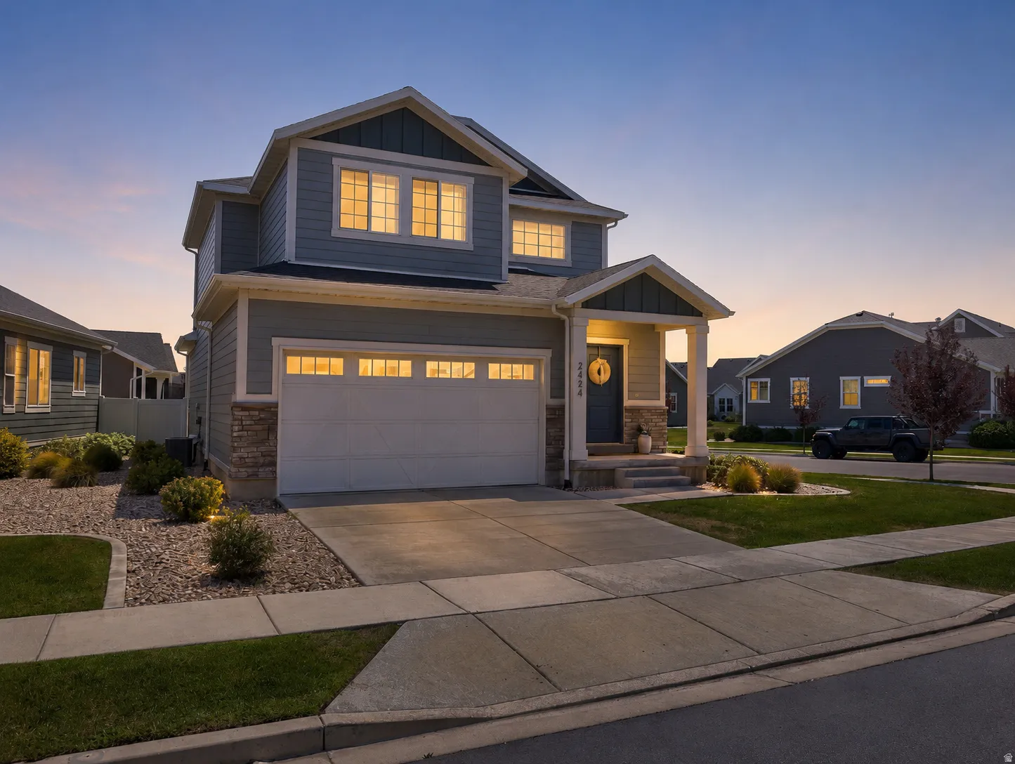 Modern two-story home featuring a striking gabled roofline with upper-level dormer windows