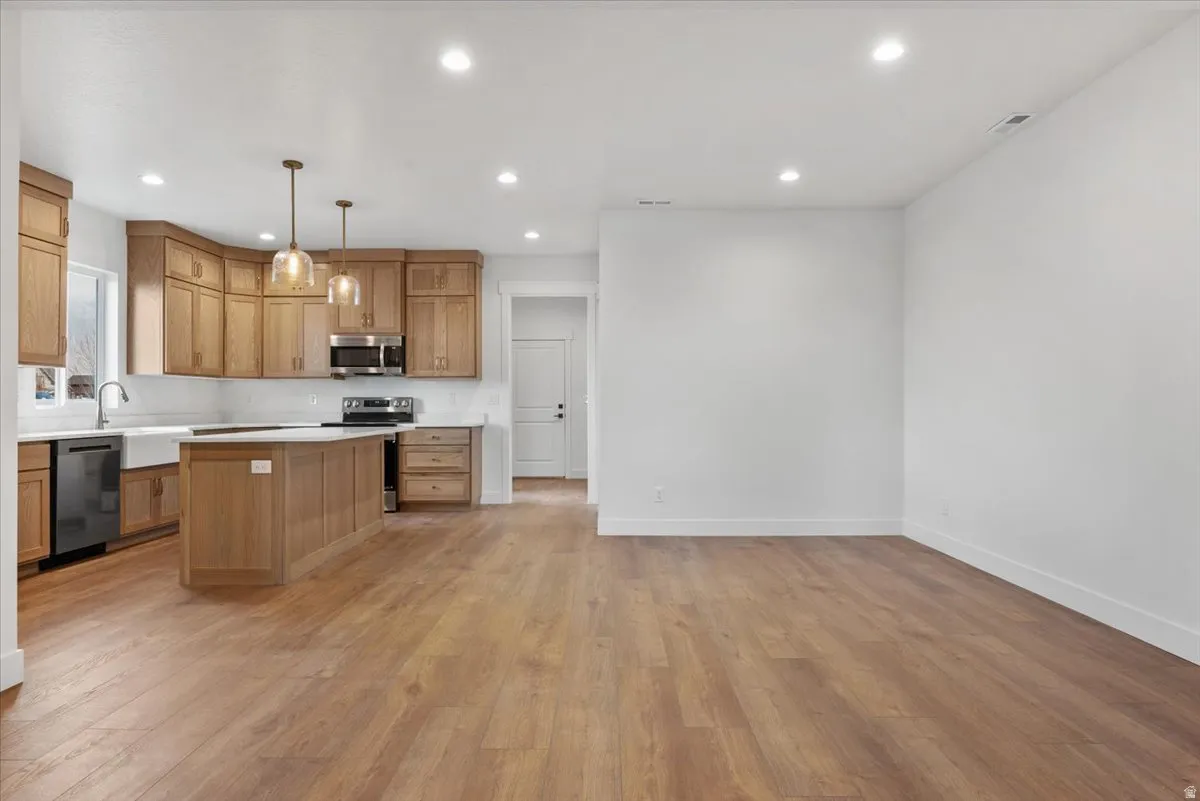 Open concept living space featuring wood-finish flooring
