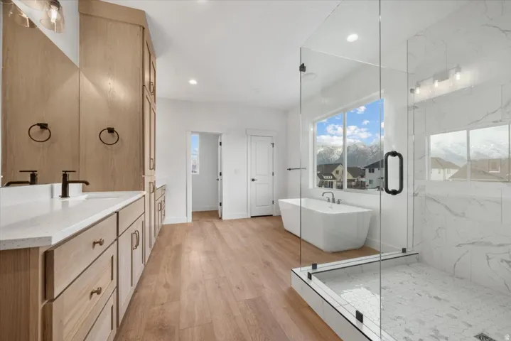 Dual vanity with light wood-finish cabinetry and white countertops