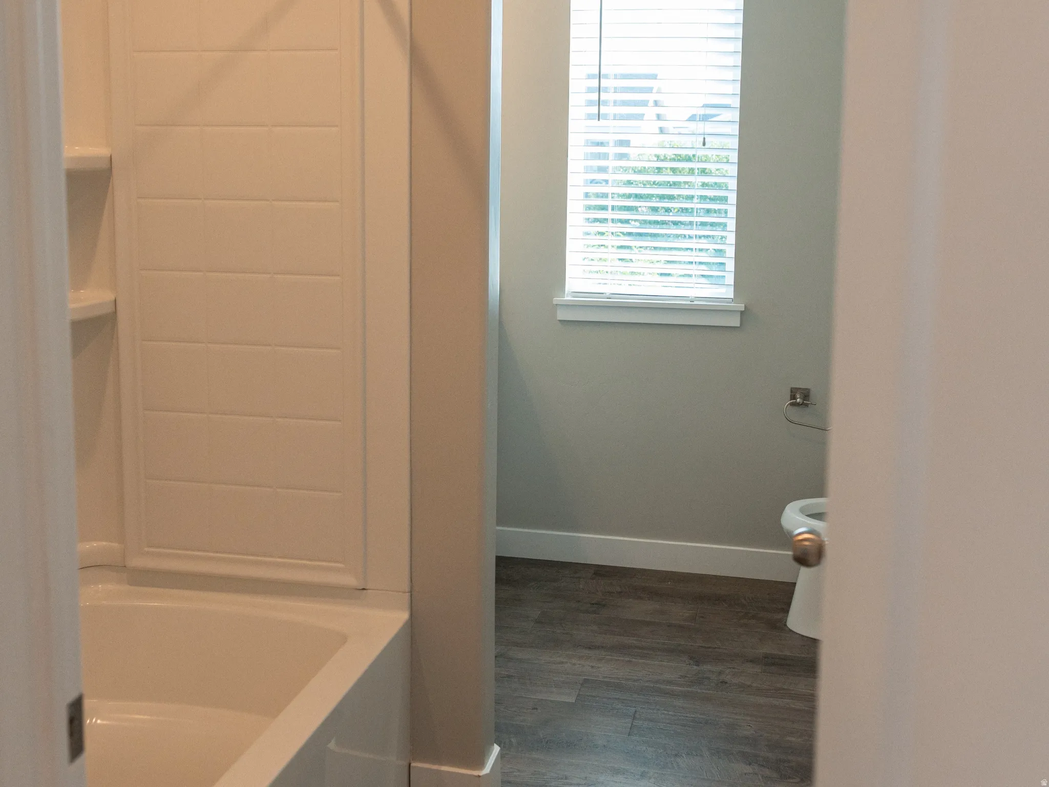 Tub and shower combination with a tile-patterned surround