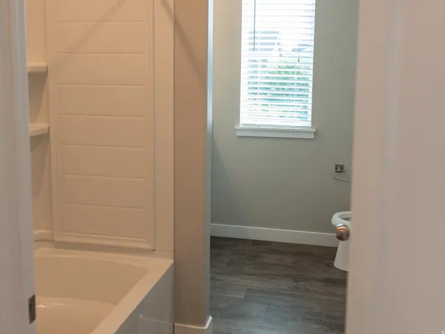 Tub and shower combination with a tile-patterned surround
