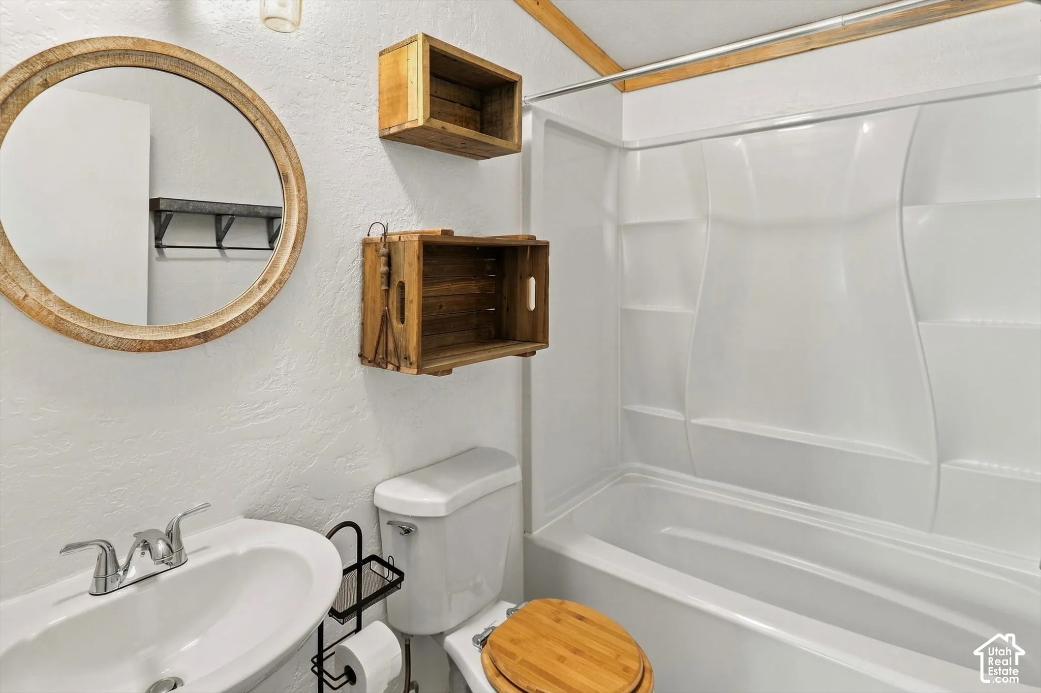 White tub and shower combination with integrated shelving