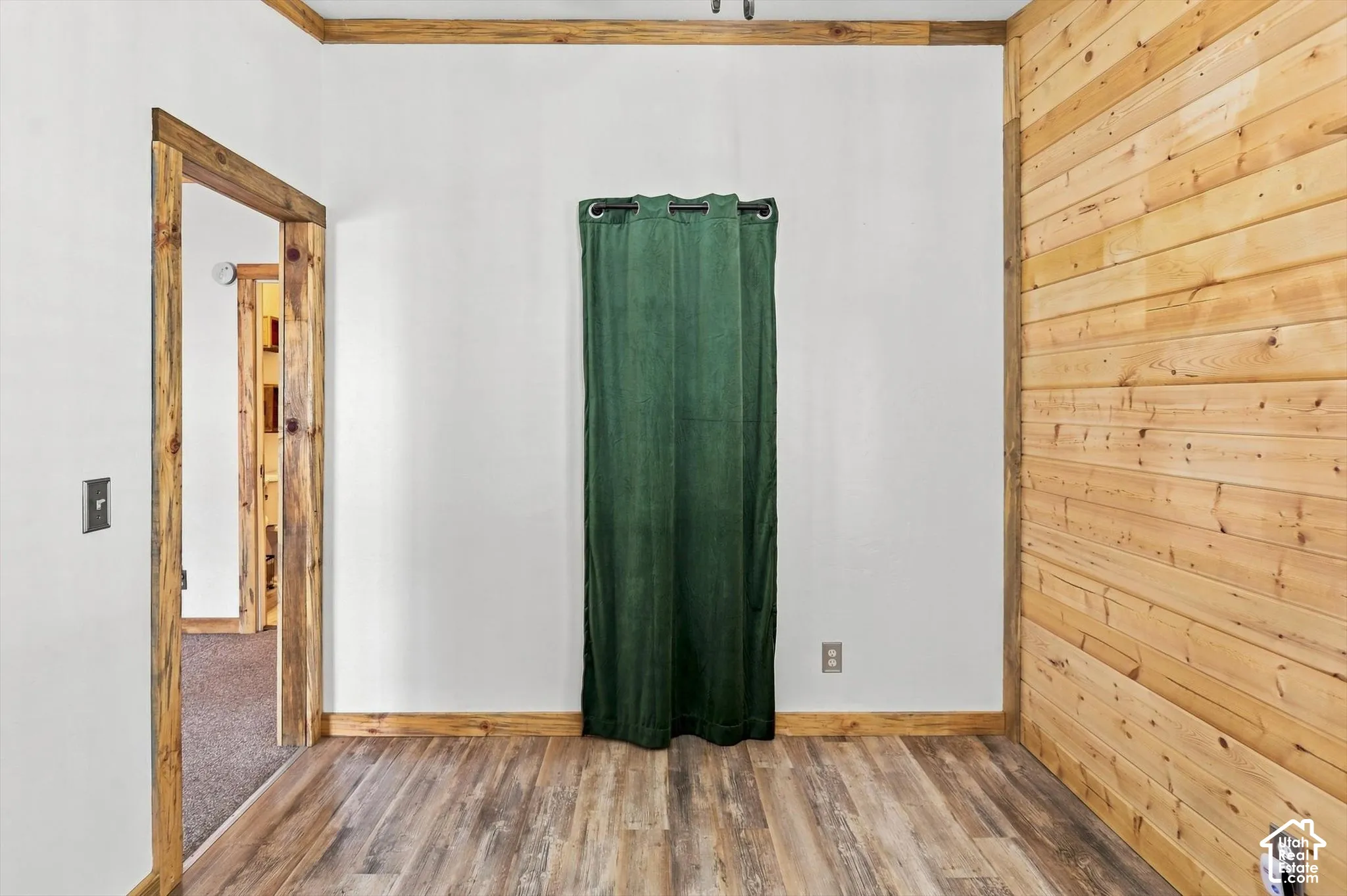 Wood-finish flooring, wood plank accent wall, and wood trim