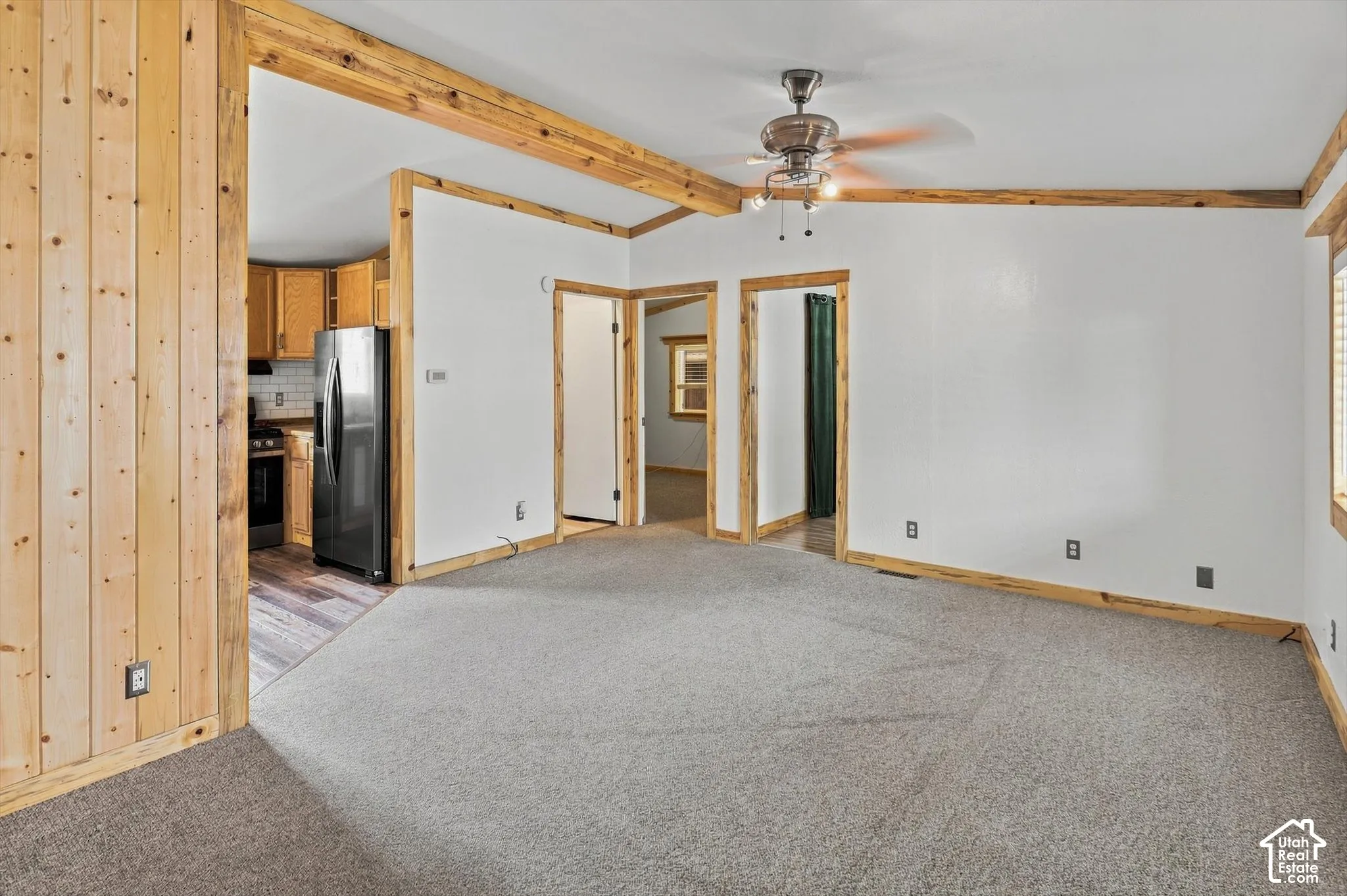 Light gray carpeting and white walls with natural wood trim