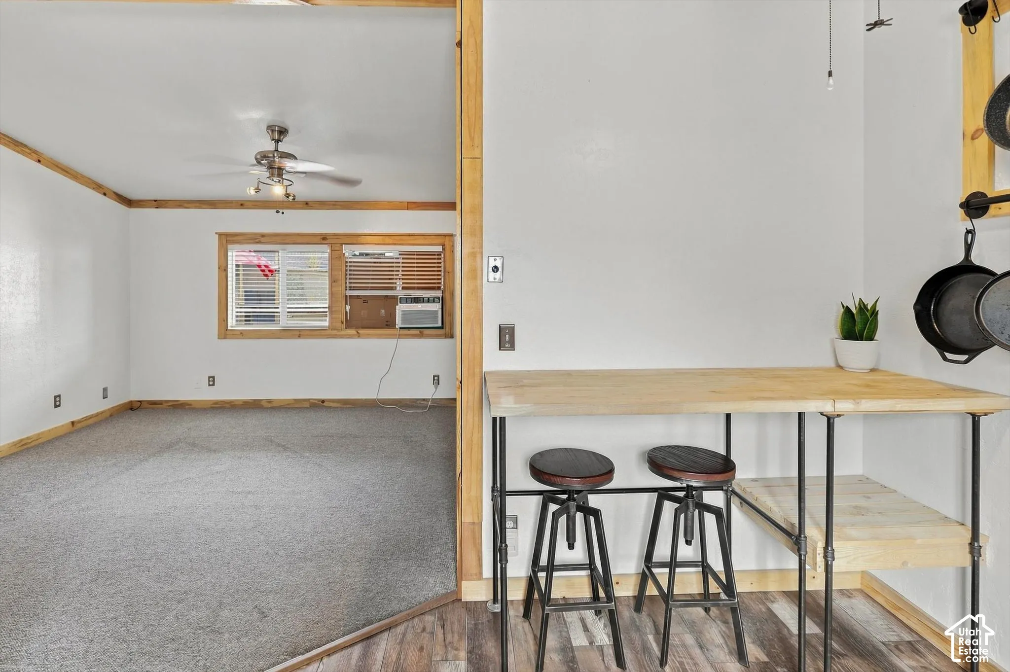 Wood-finish flooring with a breakfast bar and pendant lighting