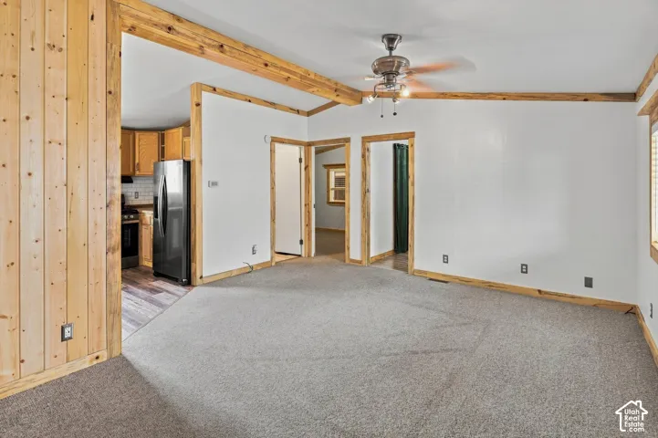 Light gray carpeting and white walls with natural wood trim