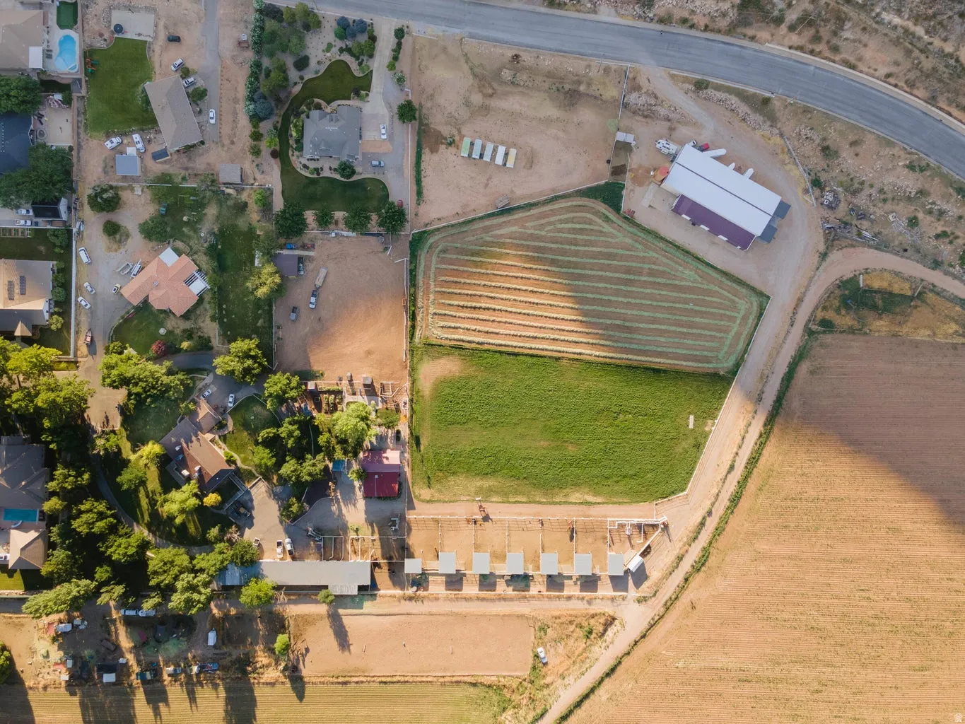 Expansive parcel featuring multiple outbuildings, fenced enclosures, and substantial open land