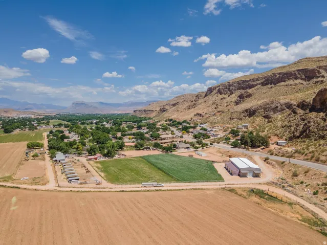 Expansive agricultural lands with established fields, multiple outbuildings, and a prominent commercial-style structure