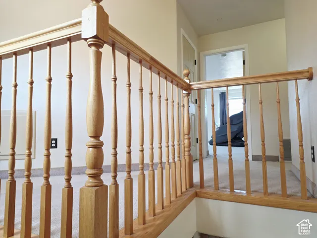 Wood-finish banister with turned spindles and a natural grain finish