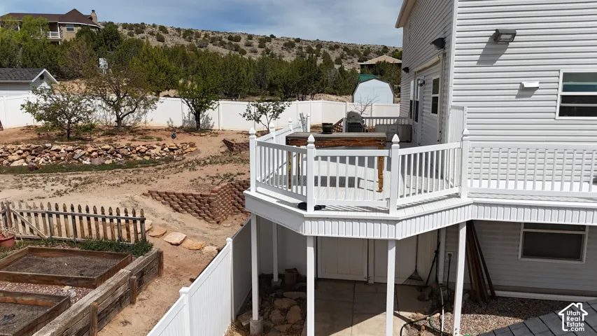 White vinyl siding exterior with an elevated deck featuring white railings
