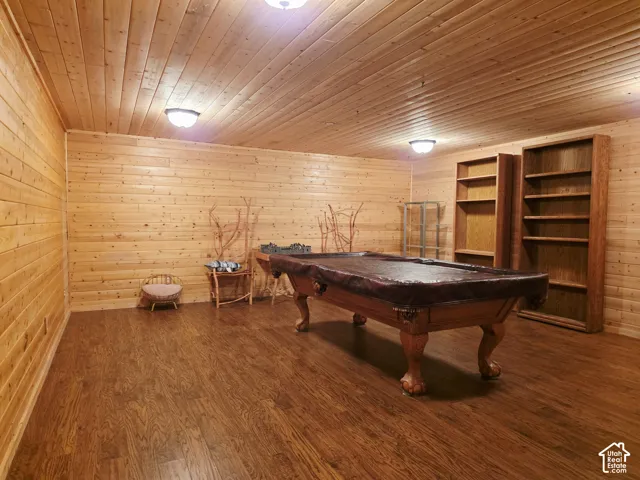 Wood-finish flooring with wood-paneled walls and ceiling