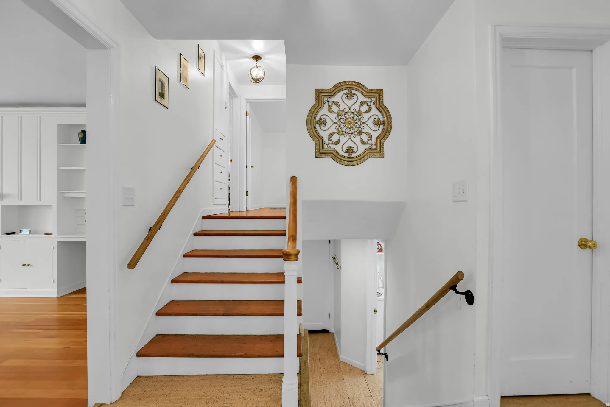 Hardwood stairs with painted risers and wood handrails
