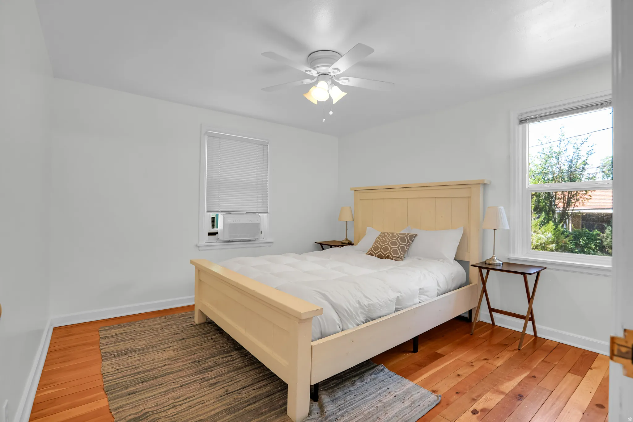 Warm wood-finish flooring complements crisp white walls