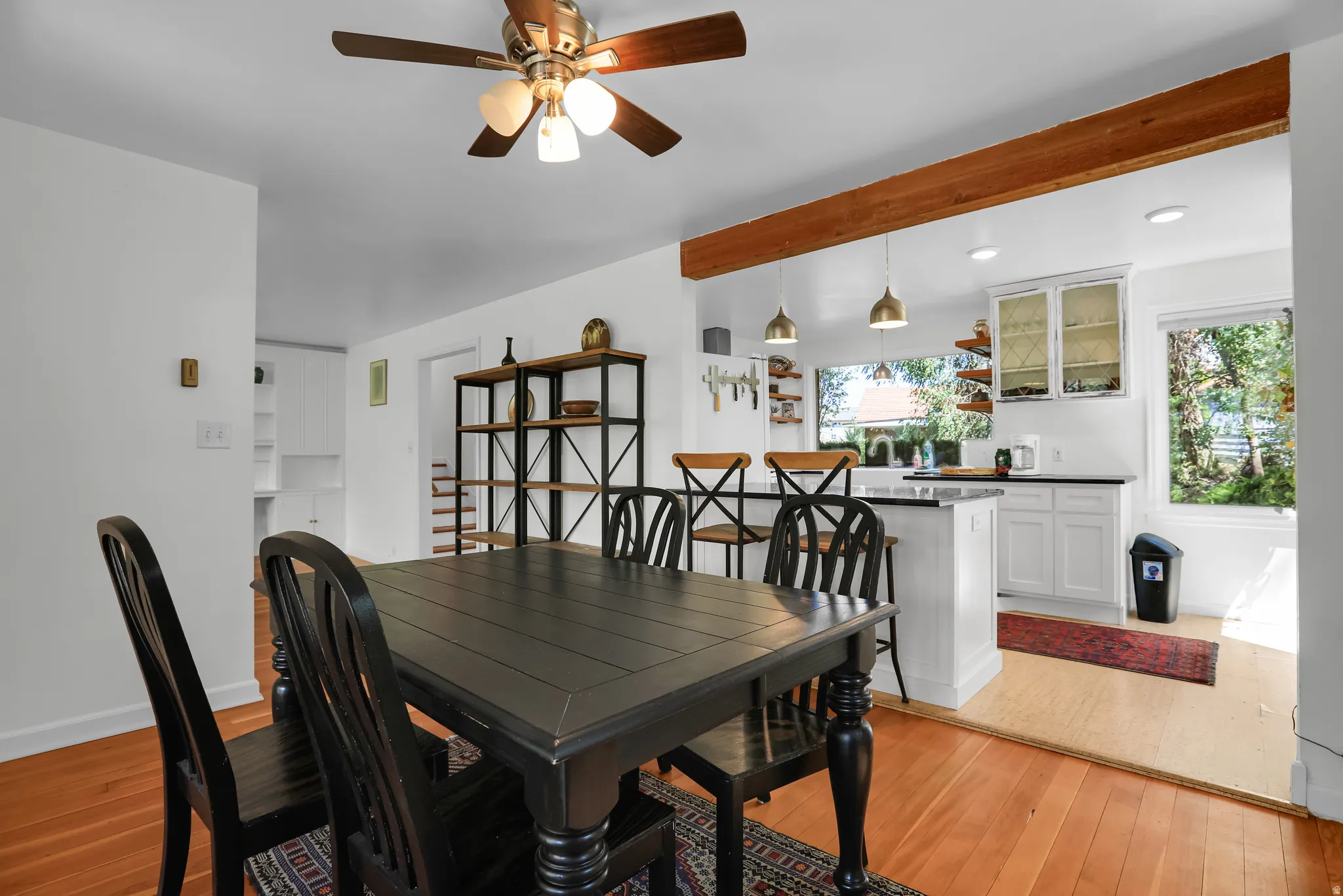 Hardwood flooring in dining area with overhead ceiling fan