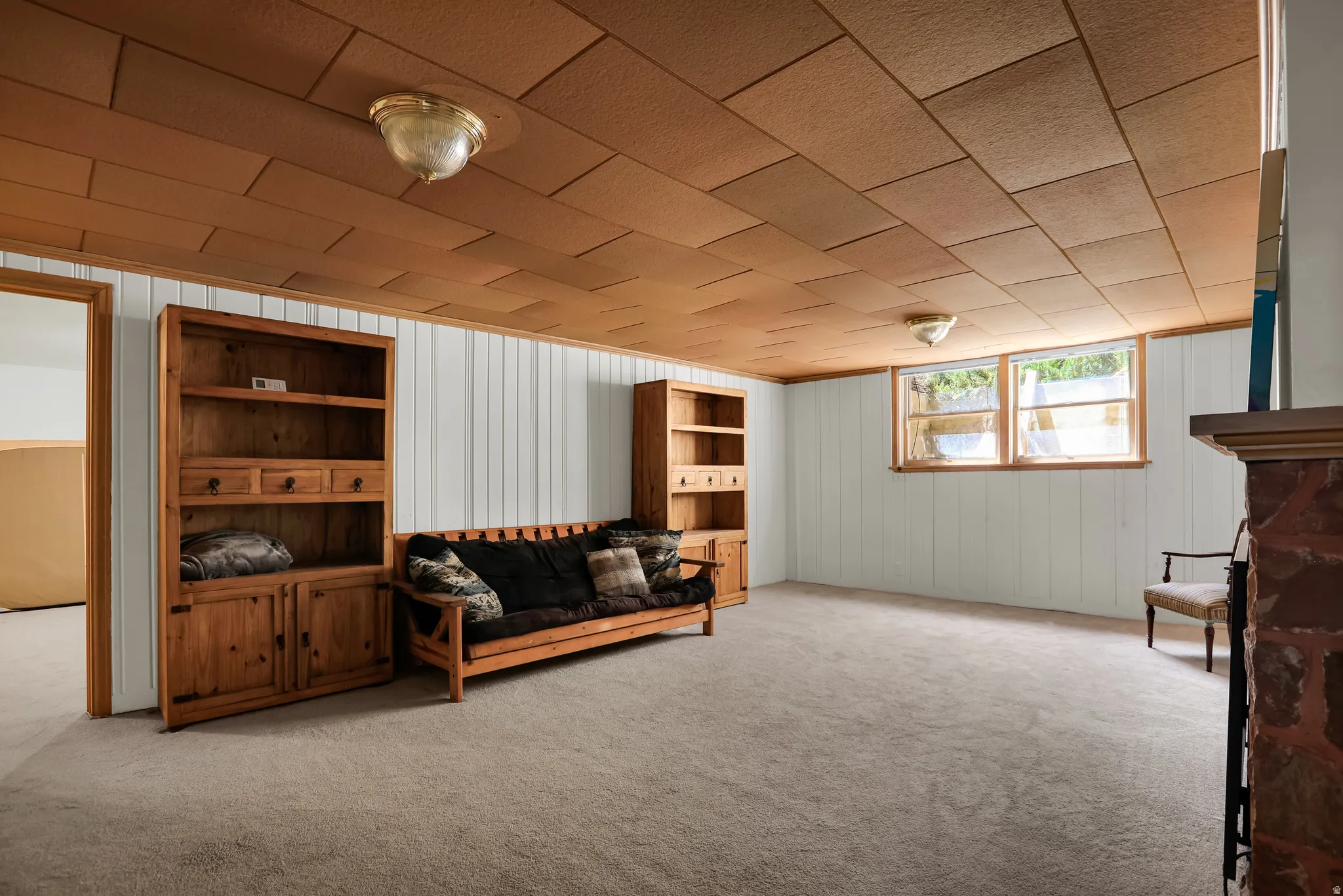 Carpeted room with white paneling and a wood-finish ceiling