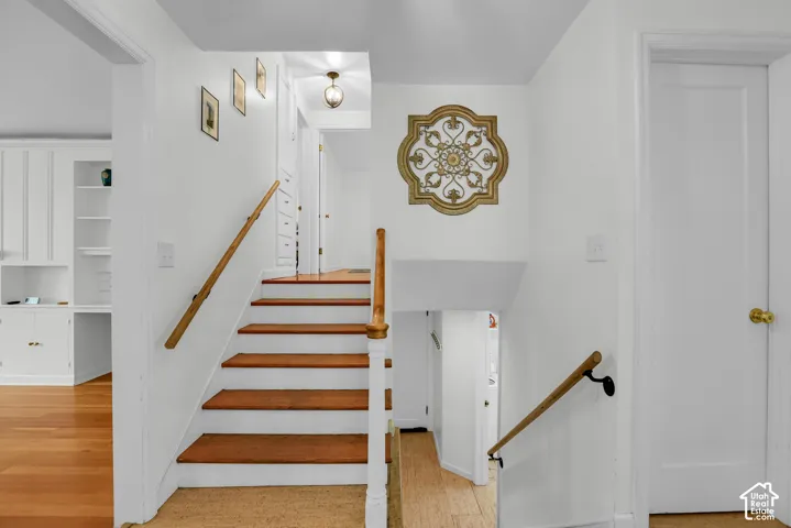 Hardwood stairs with painted risers and wood handrails