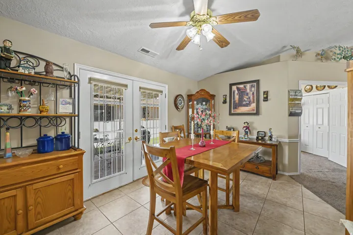 Tile flooring, vaulted ceiling, double French doors, ceiling fan with light kit, bi-fold closet doors