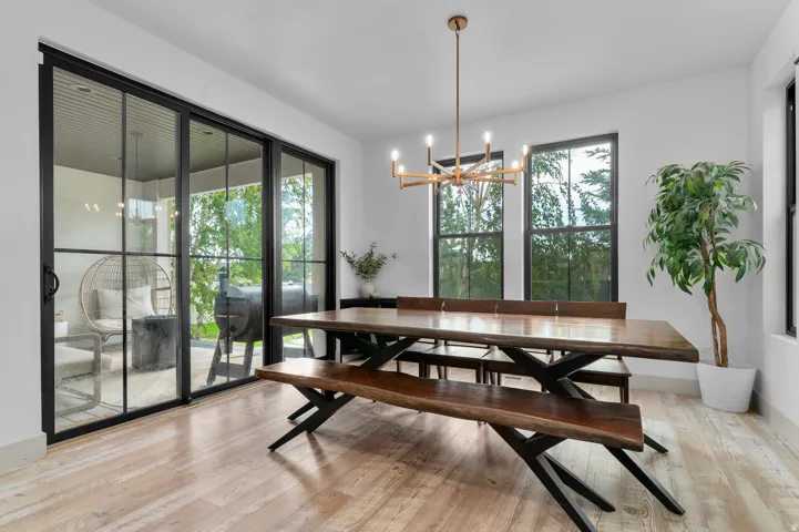 Light wood-finish flooring, white walls, and a multi-pane sliding glass door